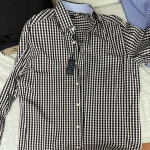 Nautica black and white plaid shirt. Brand new with tags and never worn.